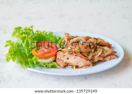 a photo of grilled neck pork with spicy herb,thai tradition food