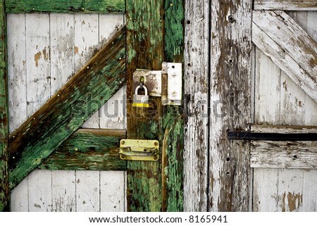 Weathered door held shut with padalock