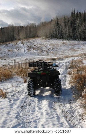 ATV with Gun Case on Snowy Four-Wheeler Trail