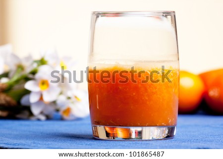 A fresh orange smoothie made with fresh fruit