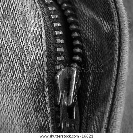 A pair of jeans close up with the fly part way down