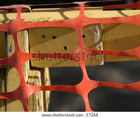 Plastic snow fence, or danger fence on a saw horse.  Good for a background or texture image.