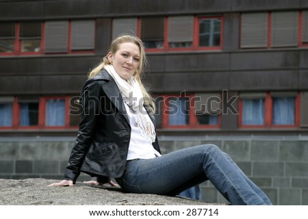 Young woman sitting in the city