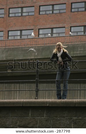 Woman thinking, leaning on a rail