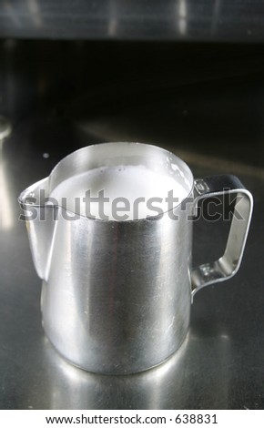 Milk Steaming mug filled with warm milk
