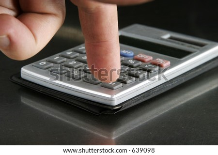 Very dirty Small personal calculator detail with a finger pressing the equals sign
