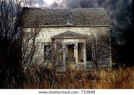 An old abandoned farm house on the prairie that looks haunted