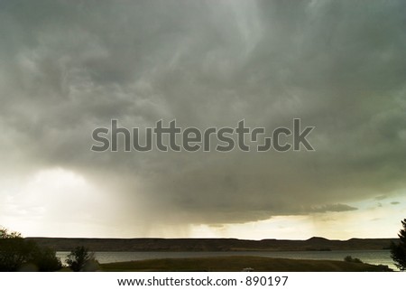 Rain clouds on the horizon over a Saskatchewan landscape.