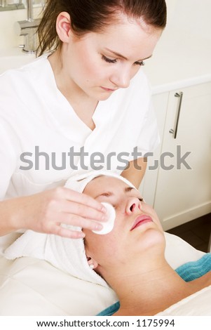 Lotion being massaged of the face at a beauty spa during a facial