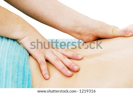 A female receives a lower back massage at a day spa.