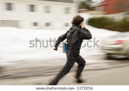 A motion blur abstract of a person walking in a hurry talking on a cell phone