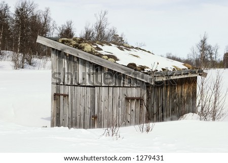 An old building in a snow filled landscape