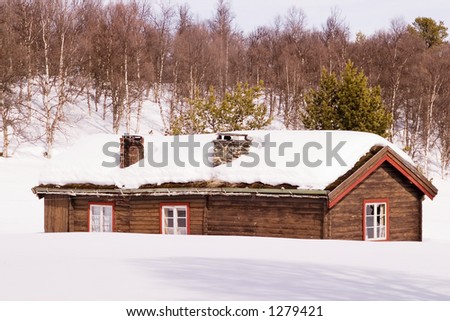 An old building in a snow filled landscape