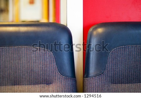 A train seat abstract with dominant blue and red colors.