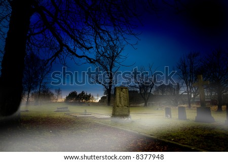 A spooky graveyard at sundown with mist