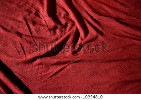 A red cloth texture with strong contrast and lines