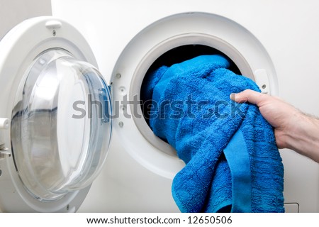 stock-photo-washing-clothes-in-a-front-loading-washer-12650506.jpg