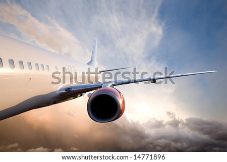 An airplane flying over a dramatic sky