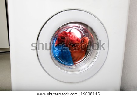 Washing machine detail with colorful clothes