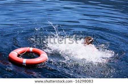 A man struggling for a life buoy in the water