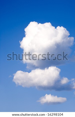 Three fluffy clouds floating in the sky