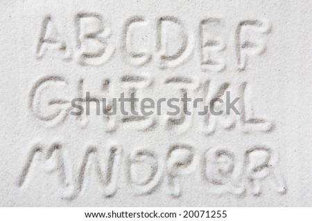 First half of an upper case alphabet written in sand - a designers tool