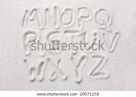 Second half of an upper case alphabet written in sand - a designers tool