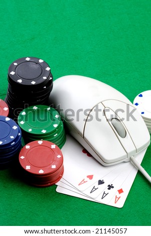 Online gaming and gambling concept, green felt, a mouse and cards