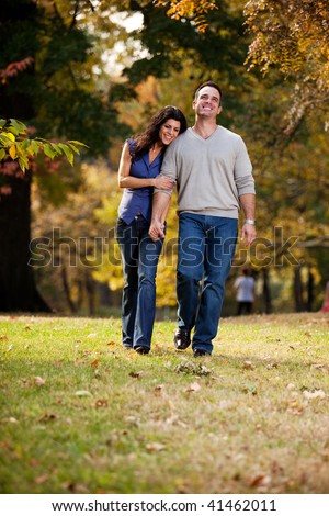stock-photo-a-happy-couple-walking-in-the-park-on-grass-41462011.jpg