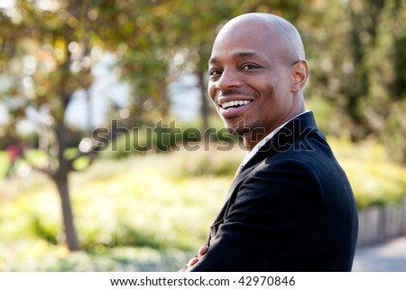 Mid adult male model in outdoor setting. Horizontally framed shot.