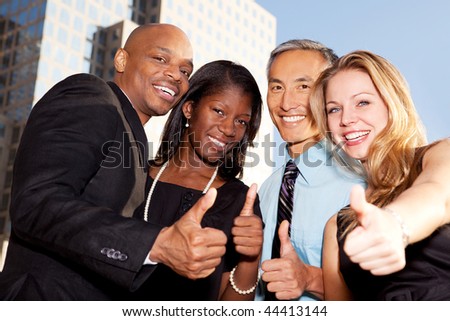 A group of business people giving a thumbs up sign