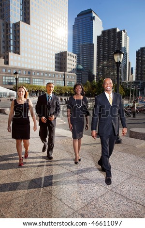 stock photo A group of business people walking down town in a large city