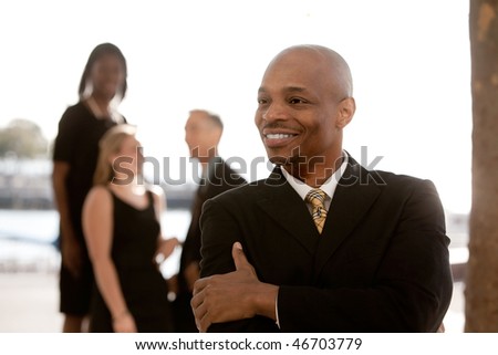 African American business man in front of business team