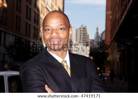 A business man isolated against a street background