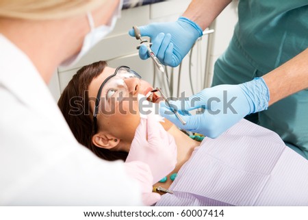 A dentist giving a freezing needle to a worried patient