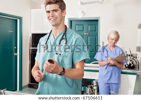 Doctor with female assistant in preparation for treatment