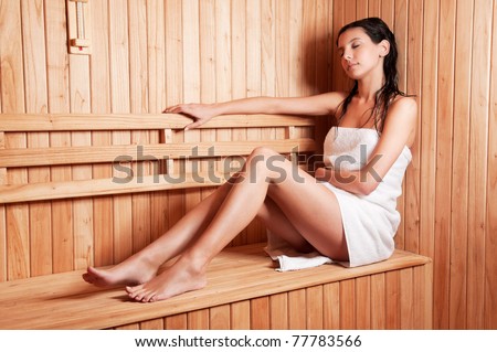 Beautiful young woman relaxing in a finish sauna