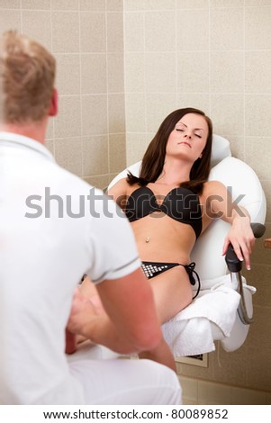... A young female wearing a bikini receiving a pedicure and foot massage in ... A young female wearing a bikini receiving a pedicure and foot massage in