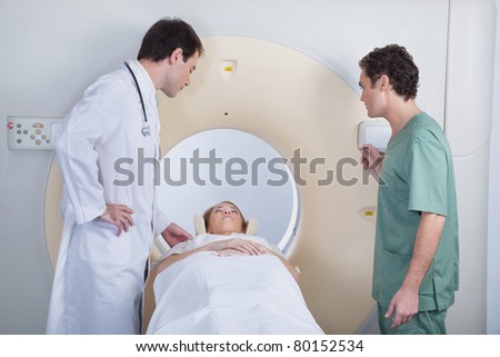 Doctor with technician examining patient before CT scan test