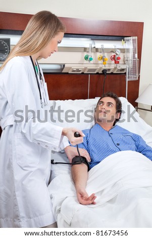 Doctor checking the blood pressure of young patient in hospital