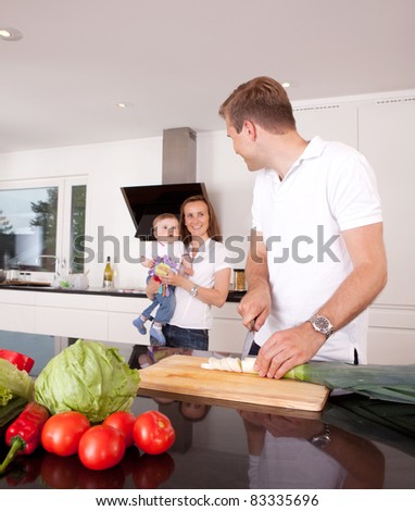 Mother, father and son in kitchen, shallow depth of field with critical focus on father