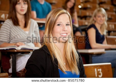 Happy young student at university class