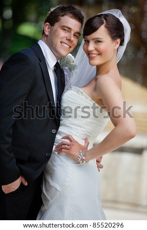 Portrait of cute young married couple posing