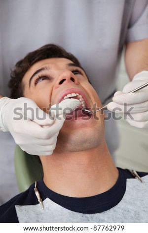 Dentist putting in molds in patients mouth
