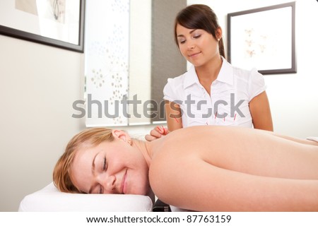 Portrait of a relaxed patient receiving an acupuncture treatment