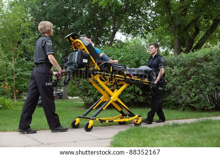 Medical team transporting patient on stretcher