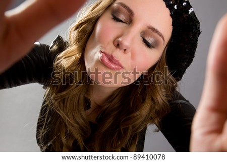 Wide angle portrait of an attractive woman ready to kiss the viewer