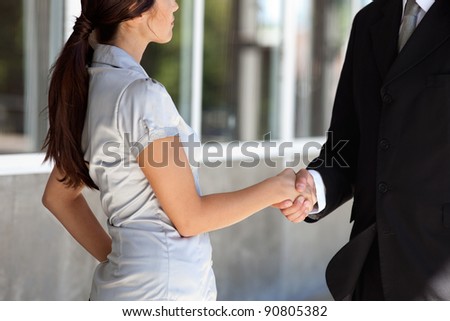Faceless professional businesspeople shaking hands
