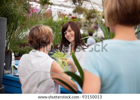 Customers at reception desk buying plants