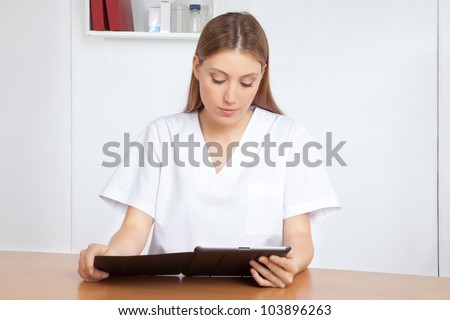 Medical professional using digital tablet.